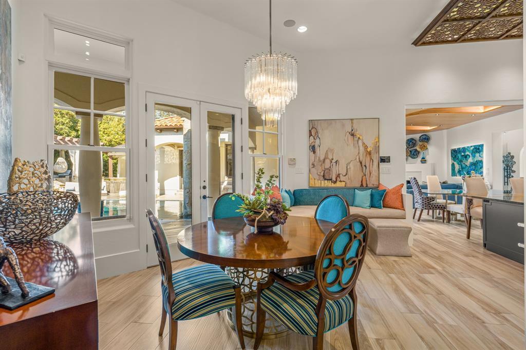 Breakfast area open to the great room, French doors opening to the pool courtyard