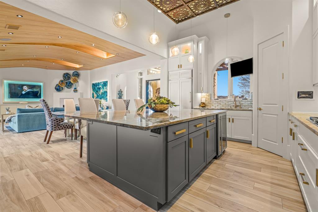 Open-plan view from the kitchen island through to the family room's curved wood ceiling