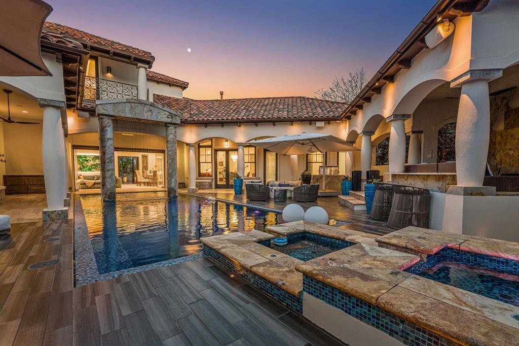 Backyard from spa level, the pool running to the house under the columned loggia